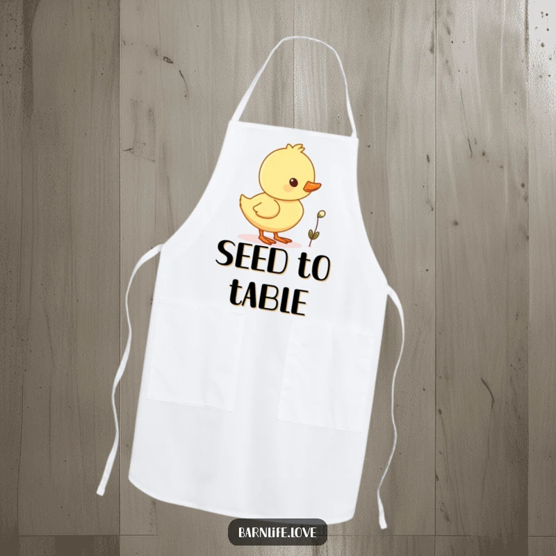 Funny duckling waddling apron featuring a cheerful baby duck with a tiny seed, perfect for kitchen fun.