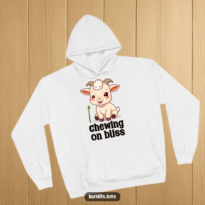 Funny goat munching hoodie featuring a content goat eating a dandelion, providing warmth and humor.