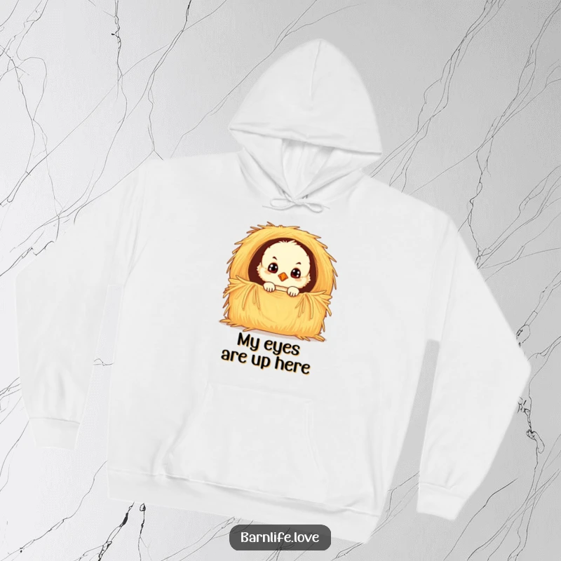 Funny chick hoodie depicting a fluffy baby bird with wide, curious eyes peeking from a hay bale, offering warmth and a touch of playful charm.