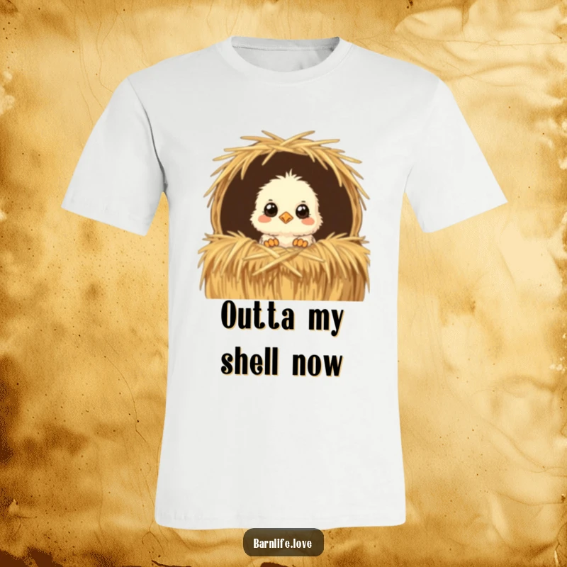 Funny T-Shirt with a fluffy baby chick peeking curiously from a straw bale, offering a humorous and endearing farm animal graphic.