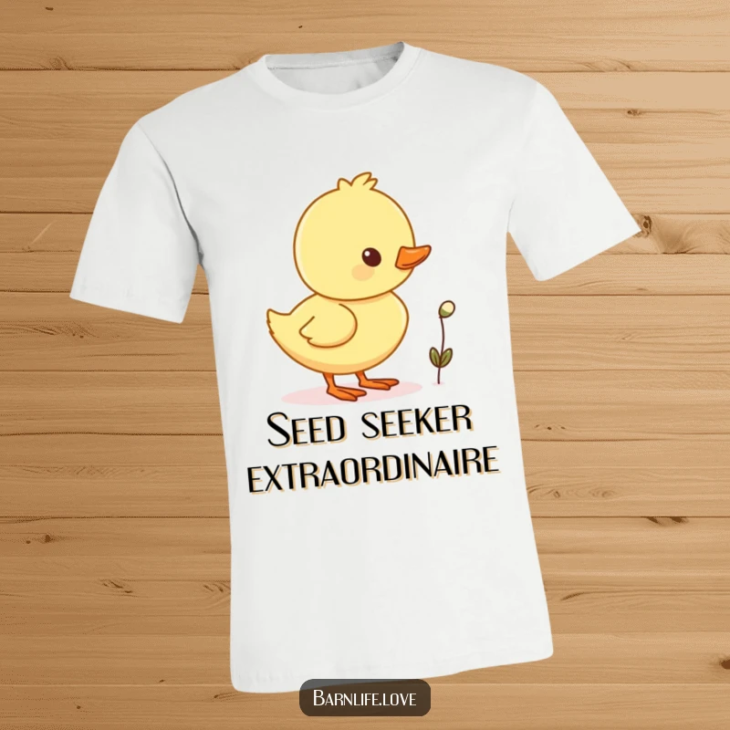 Funny duckling waddling t-shirt depicting a cheerful baby duck with a tiny seed, embodying playful charm.